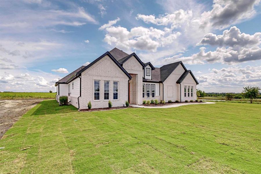 French country style house with a front yard