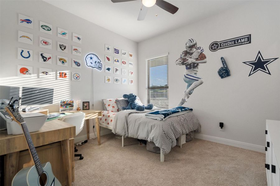 A well-lit bedroom features plush carpeting and a bright window with blinds, creating a comfortable and inviting atmosphere. A well-lit bedroom features plush carpeting and a bright window with blinds, creating a comfortable and inviting atmosphere.