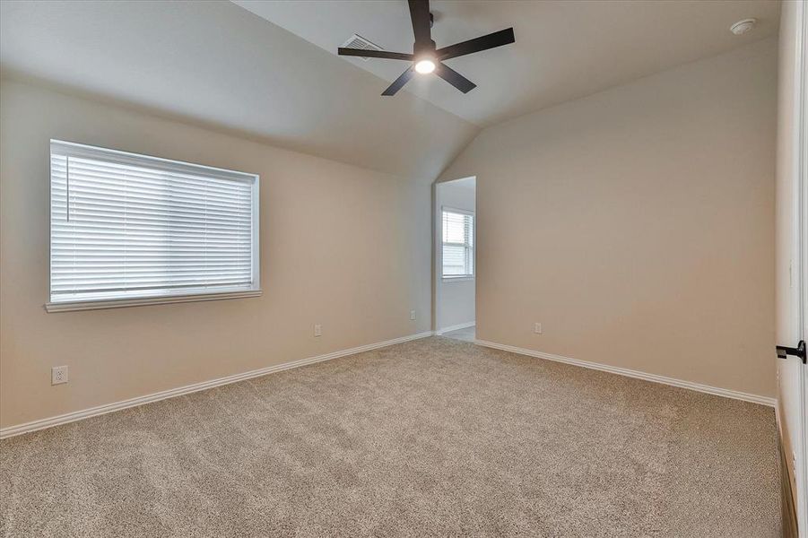 Spacious secondary bedroom features natural light, ceiling fan and like new carpet Spacious secondary bedroom features natural light, ceiling fan and like new carpet