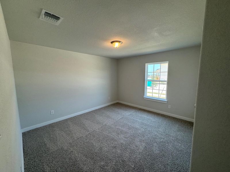 Carpeted spare room featuring baseboards and a textured ceiling Carpeted spare room featuring baseboards and a textured ceiling