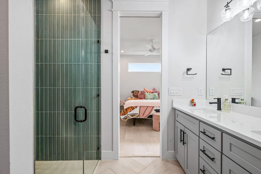 Primary Bathroom featuring double vanity, designer tile
