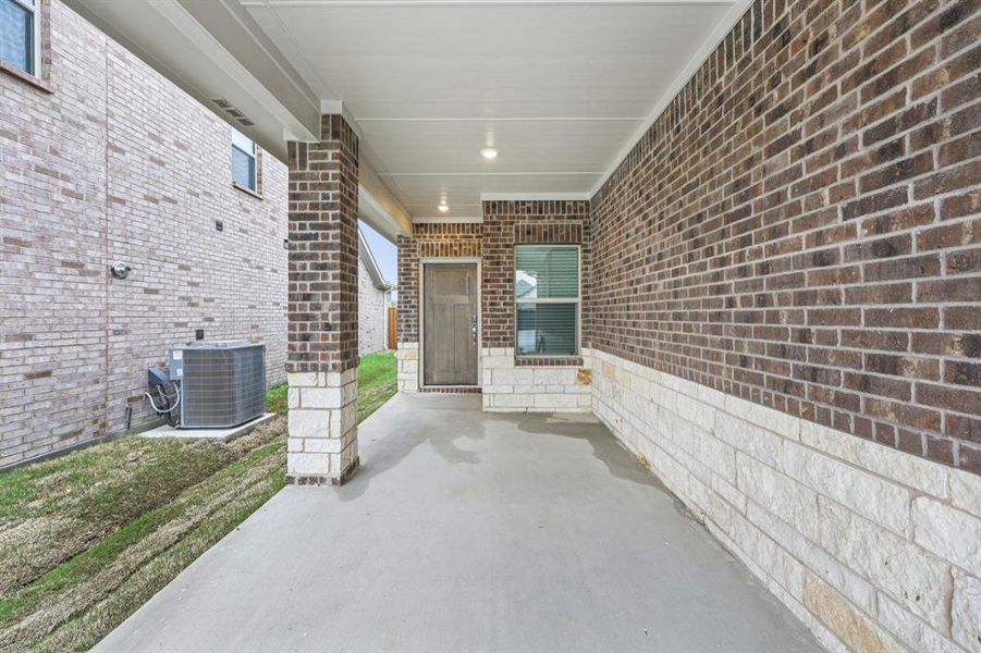 Exterior details and patio area of a home in Parks at Foster Crossing - Spring Series, Anna (Image 3).
