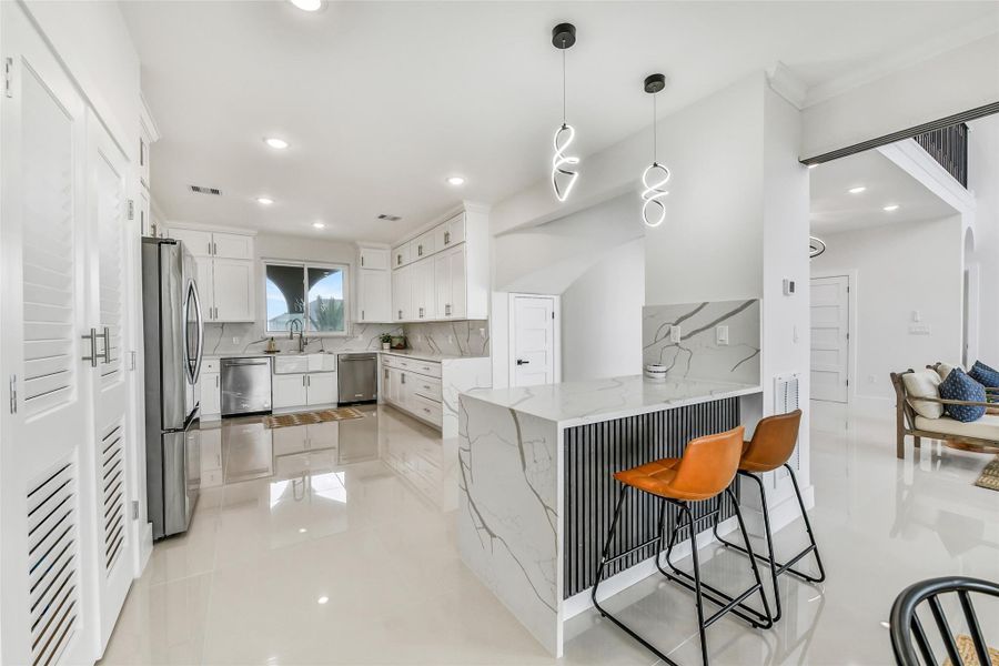 The bar anchors the space, perfect for casual dining or hosting. It naturally becomes the heart of the home.