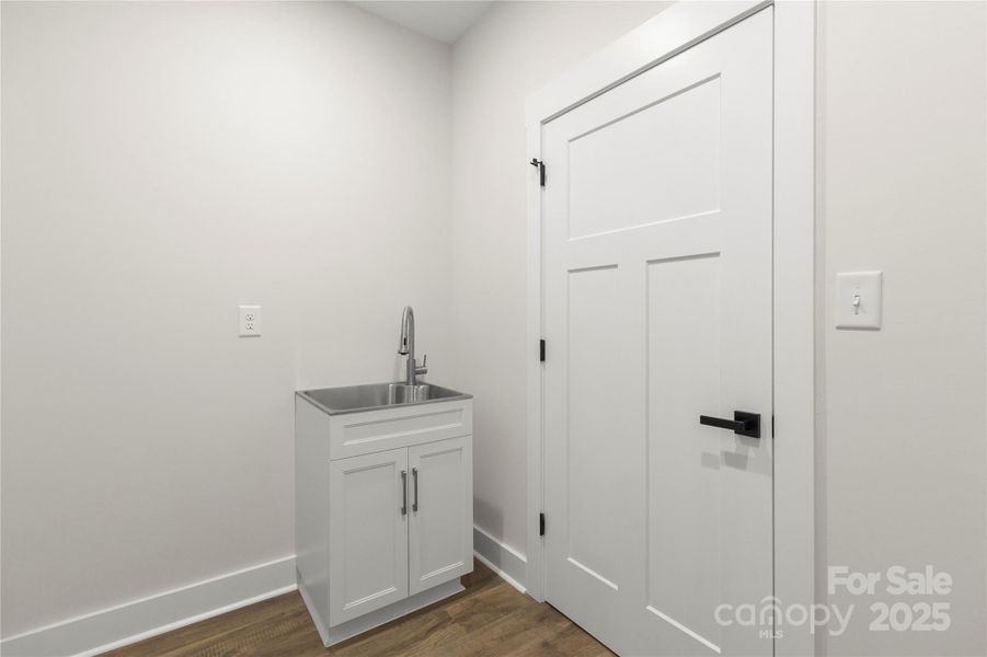 Mud room with utility sink on the other side of laundry room. This is a pass through from garage
