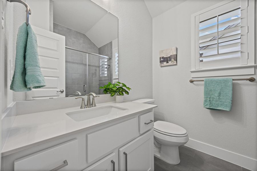 A well-appointed bathroom with a spacious vanity, sleek shower, and modern fixtures.