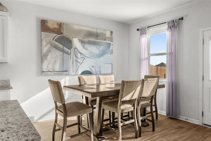 Dining area with light wood-style flooring