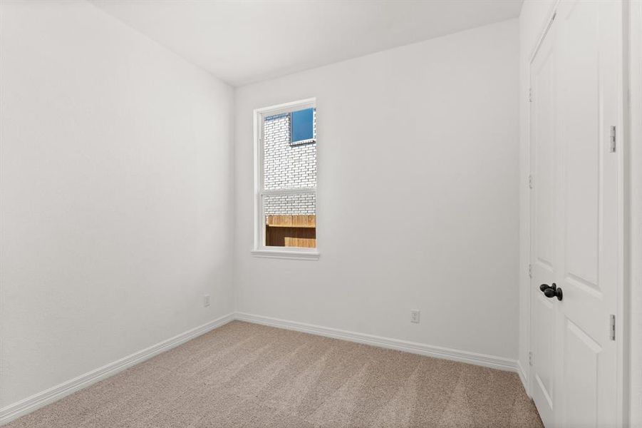 Your secondary bedroom features plush carpet, fresh paint, closet, and a large window that lets in plenty of natural lighting.