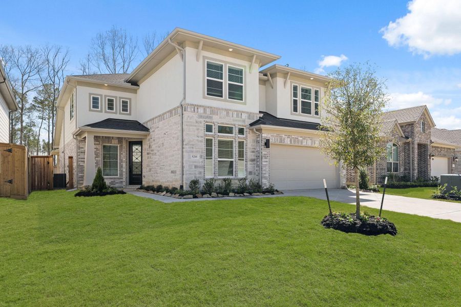 Front exterior of a new home in The Highlands 50', Porter, TX, highlighting curb appeal (Image 2). Front exterior of a new home in The Highlands 50', Porter, TX, highlighting curb appeal (Image 2).