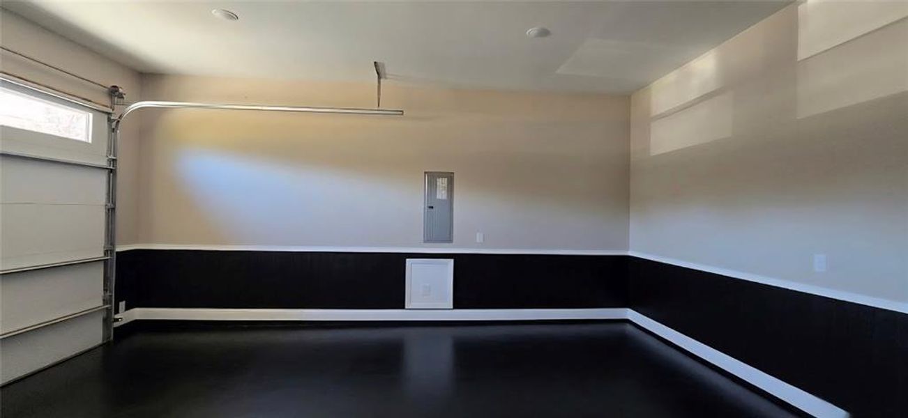 Garage featuring wainscot and AI generated planned finished flooring ( color may vary) Garage featuring wainscot and AI generated planned finished flooring ( color may vary)