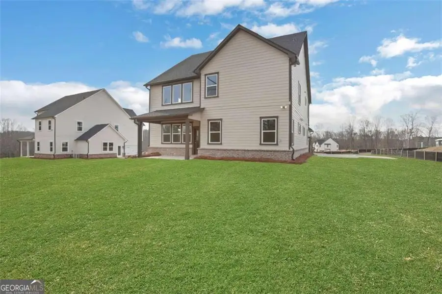Exterior details and patio area of a home in The Paddocks at Doc Hughes, Buford (Image 4).