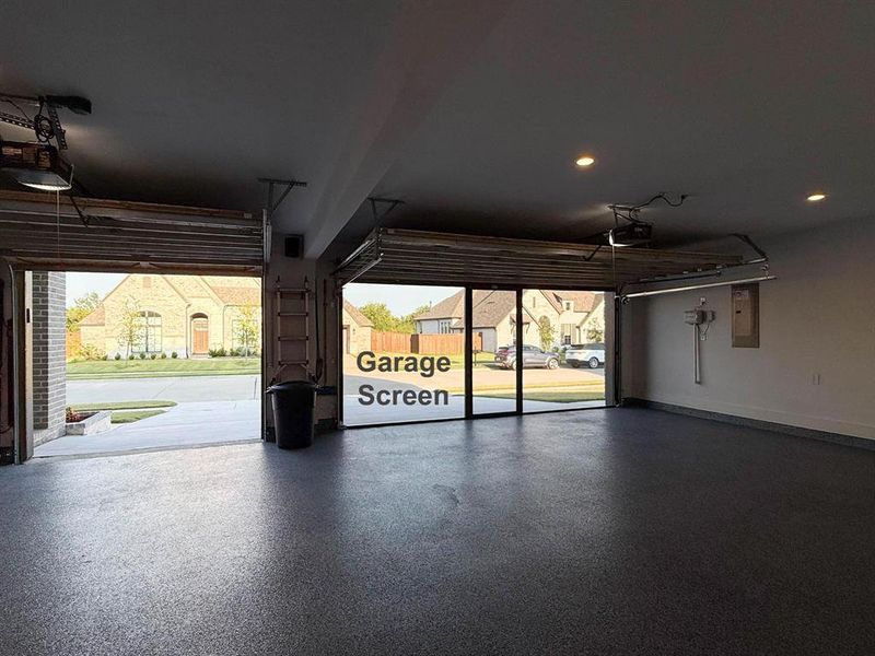 Garage featuring electric panel, a garage door opener, and recessed lighting Garage featuring electric panel, a garage door opener, and recessed lighting