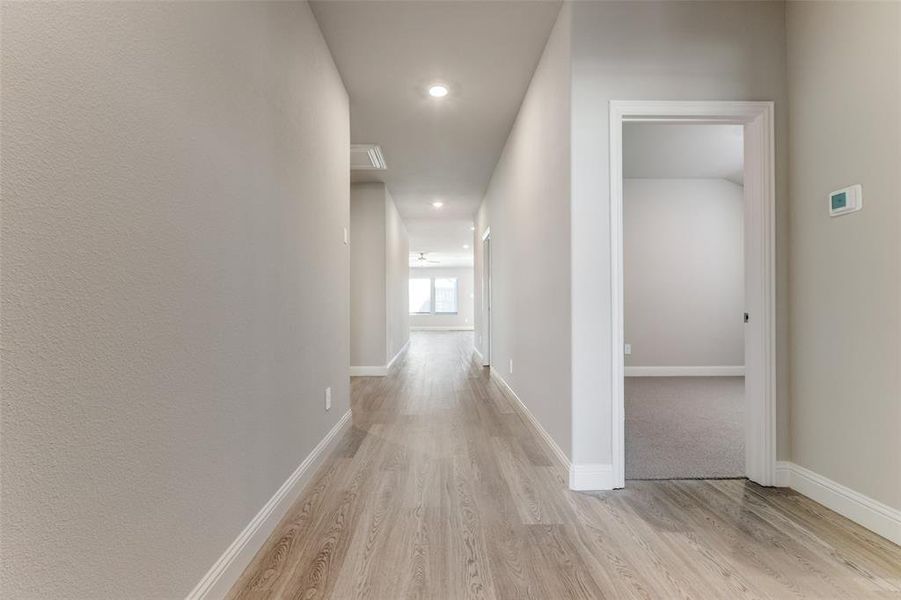 Hall featuring light wood-style floors and recessed lighting