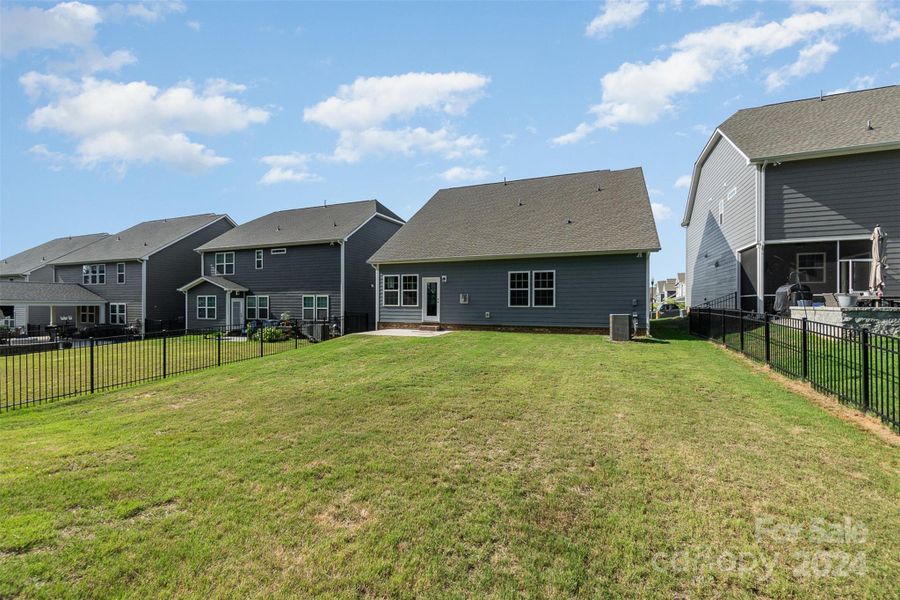 Back of house with flat backyard