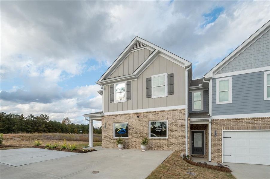 Front exterior of a new home in Creekside Village, Lithonia, GA, highlighting curb appeal (Image 23).