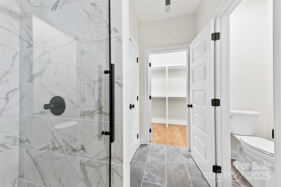 Custom Walk in Tiled Shower & Closet in Primary Bath