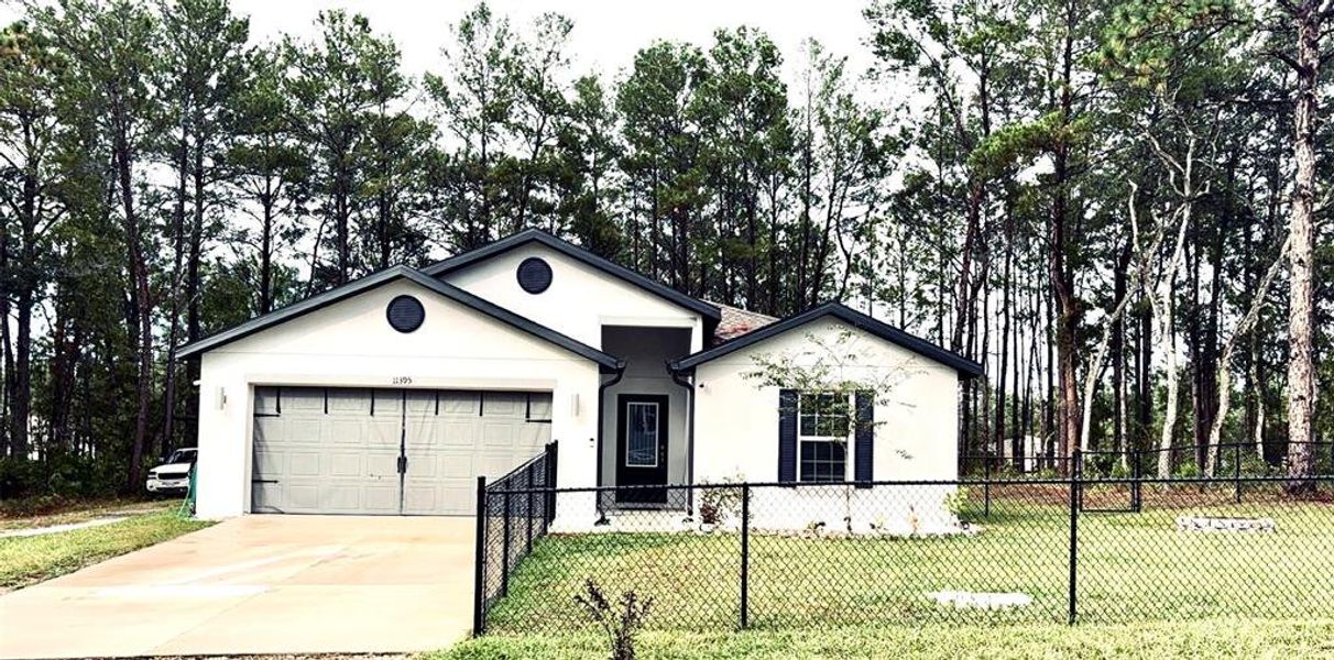 Front exterior of a new home in Royal Highlands, Weeki Wachee, FL, highlighting curb appeal (Image 1).