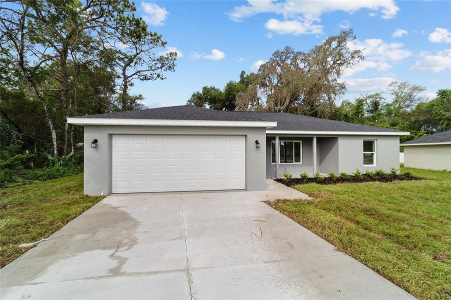 Front exterior of a new home in , Dunnellon, FL, highlighting curb appeal (Image 32).