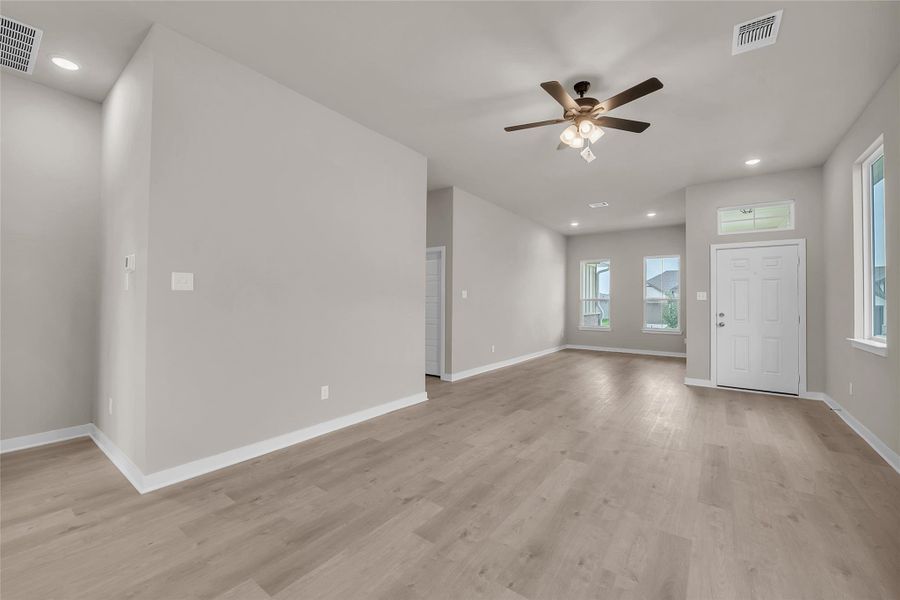 Unfurnished living room with recessed lighting, ceiling fan, and light wood-style floors