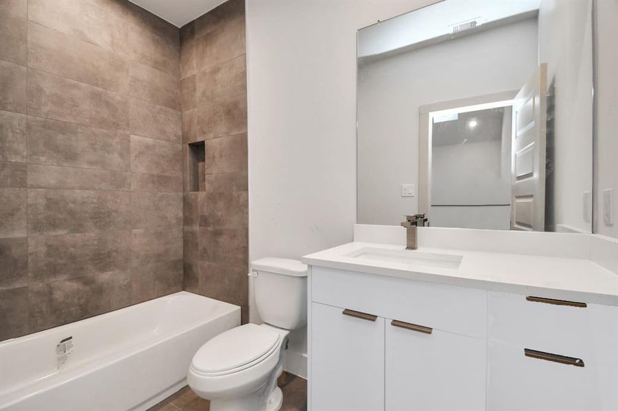 Full Bathroom 2 with Quartz Countertops and Tiled to Ceiling Walls