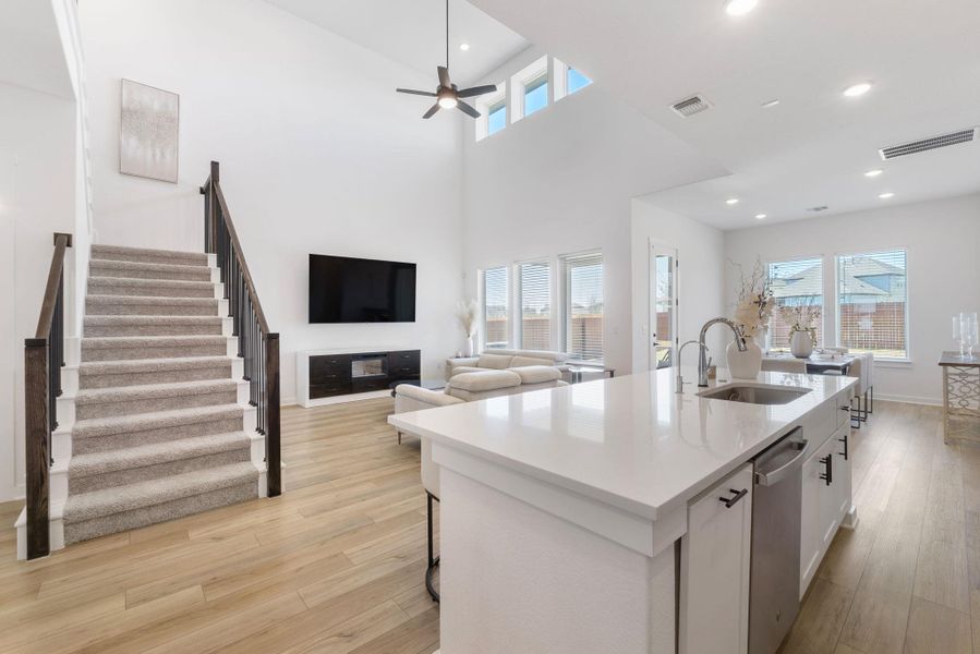 Kitchen with a sink, visible vents, dishwasher, and light wood-style flooring