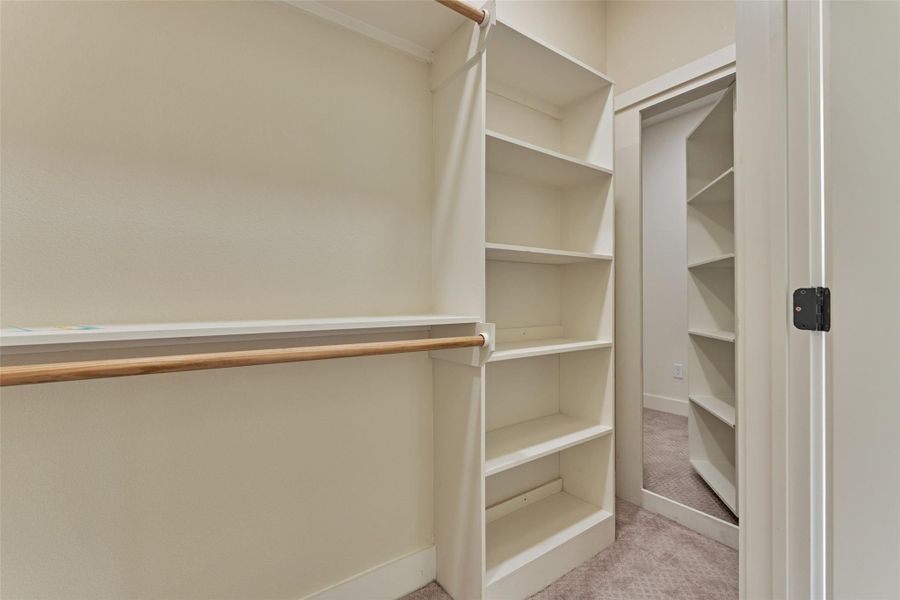 Walk-in closet with built-in shelving and hanging rods — plus a hidden passage that leads to a secret bonus room. Storage and imagination in one. Walk-in closet with built-in shelving and hanging rods — plus a hidden passage that leads to a secret bonus room. Storage and imagination in one.