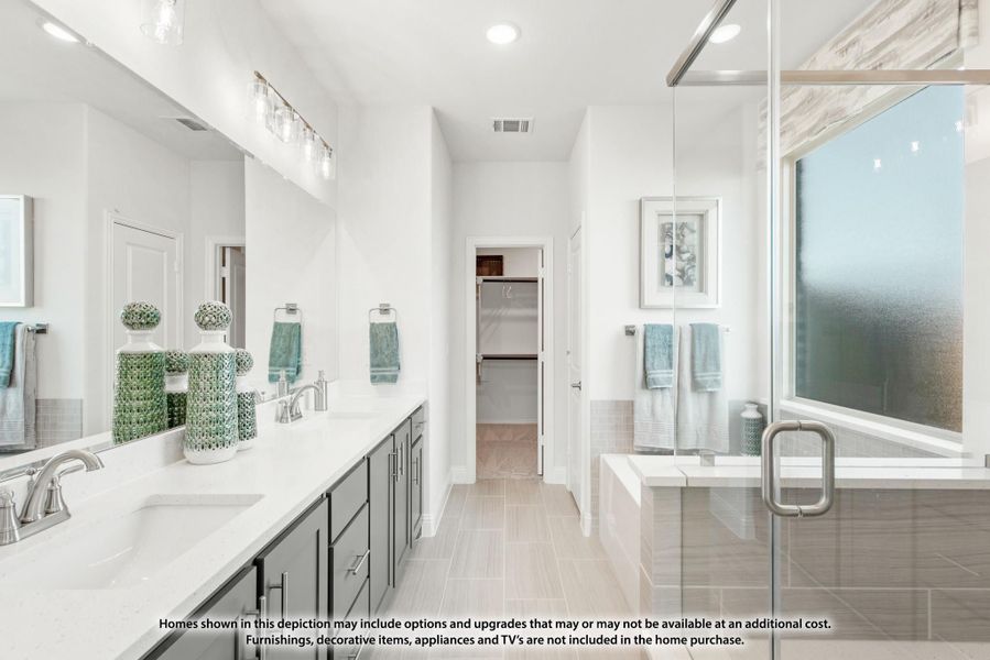 Master bathroom with double vanity, glass shower, soaking tub, and walk-in closet entry Master bathroom with double vanity, glass shower, soaking tub, and walk-in closet entry