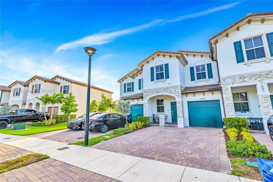 Front exterior of a new home in Westview: Nantucket Collection, Miami, FL, highlighting curb appeal (Image 23). Front exterior of a new home in Westview: Nantucket Collection, Miami, FL, highlighting curb appeal (Image 23).