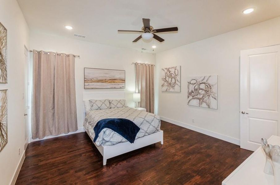 Bedroom featuring dark wood-type flooring and ceiling fan