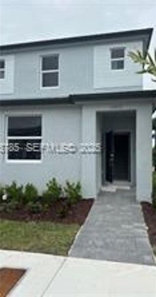 Front exterior of a new home in , Homestead, FL, highlighting curb appeal (Image 1). Front exterior of a new home in , Homestead, FL, highlighting curb appeal (Image 1).