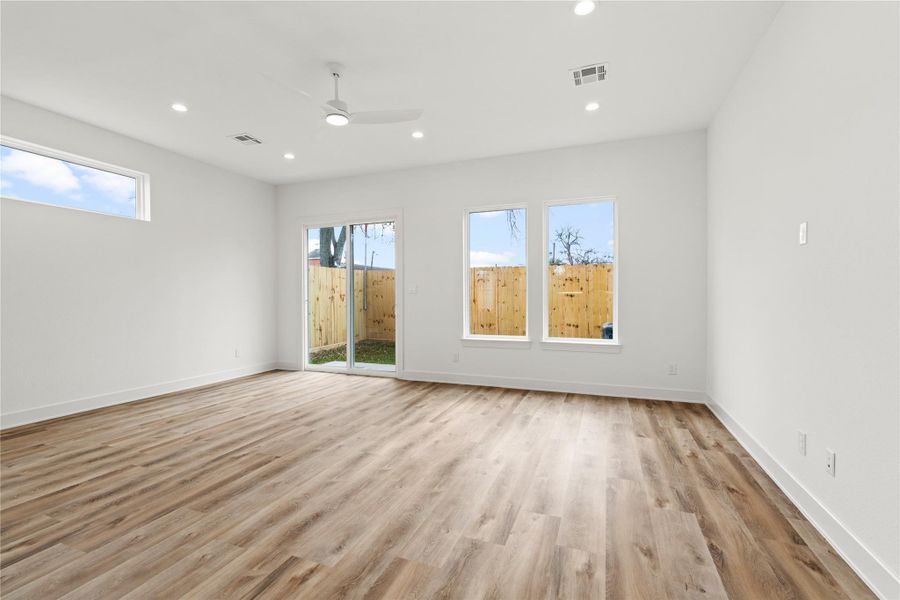 Open living space with wide-plank floors and easy access to the backyard.