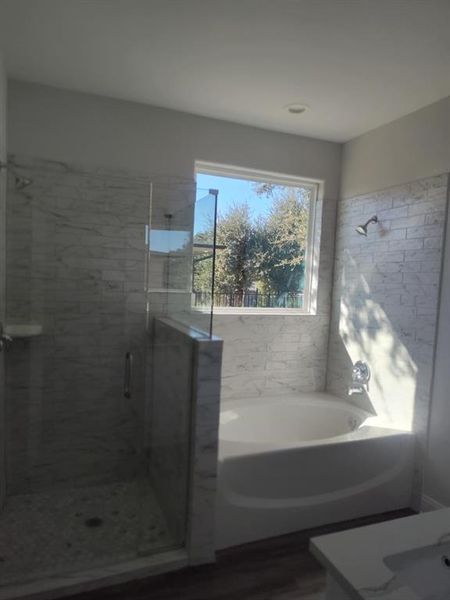 Full bath featuring a shower stall, a bath, and vanity Full bath featuring a shower stall, a bath, and vanity