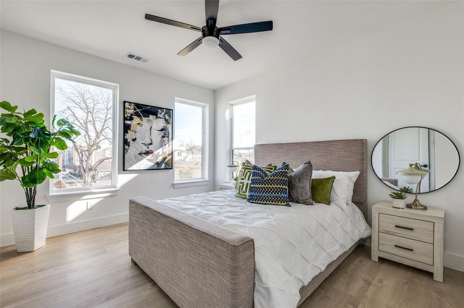 Bedroom featuring ceiling fan and light hardwood / wood-style flooring