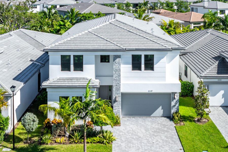 Front exterior of a new home in Lotus Edge, Boca Raton, FL, highlighting curb appeal (Image 37).