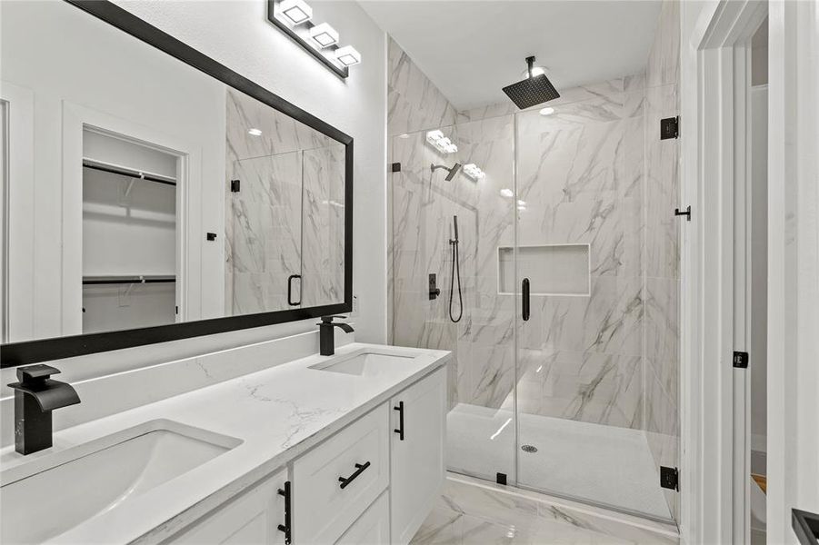 Bathroom featuring vanity and a shower with door