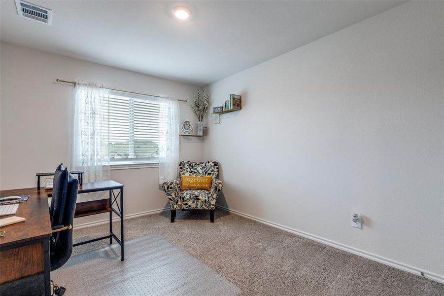 Carpeted home office with baseboards Carpeted home office with baseboards