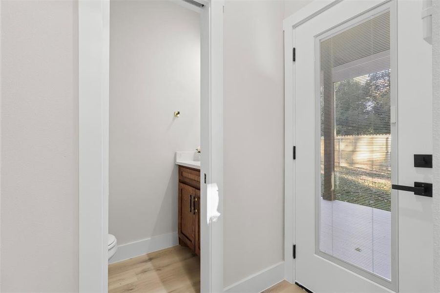 Bathroom featuring vanity, toilet, and wood-type flooring