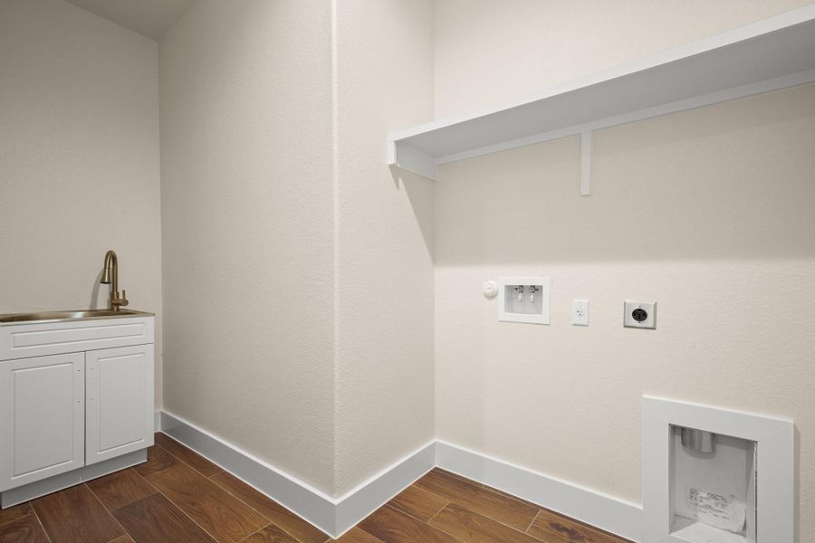 Laundry room featuring hookup for an electric dryer, hookup for a washing machine, cabinet space, dark wood finished floors, and hookup for a gas dryer