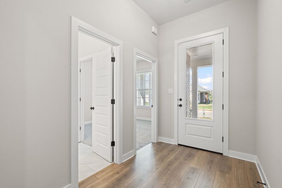Foyer featuring baseboards and light wood-type flooring