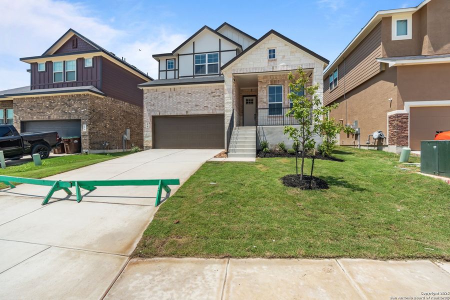 Front exterior of a new home in Hunters Ranch, San Antonio, TX, highlighting curb appeal (Image 25).