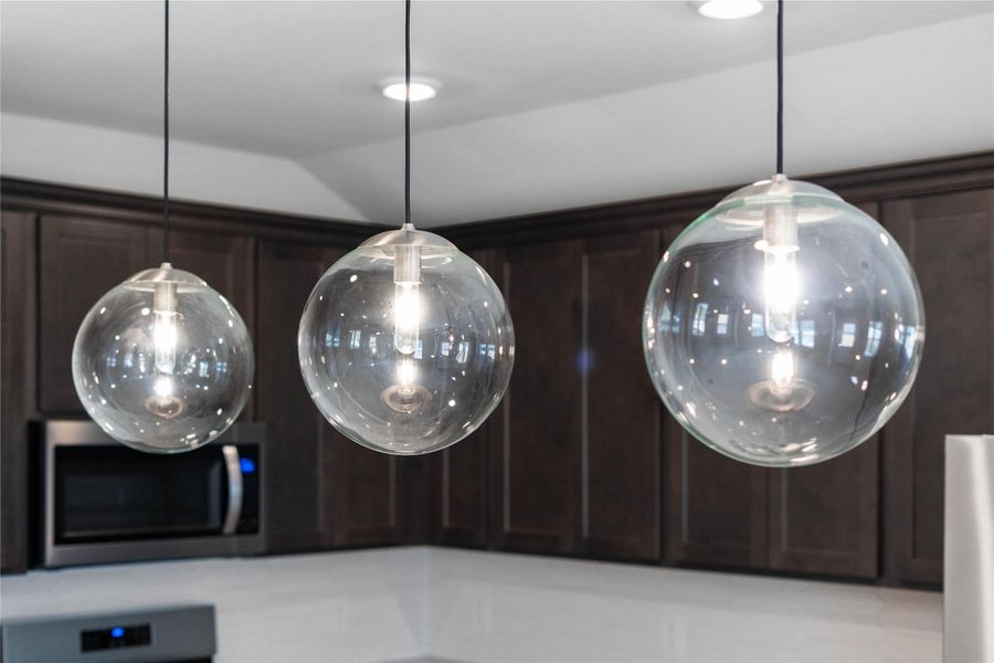 Atwell Brushed Nickel pendant lights that hang over the kitchen island.