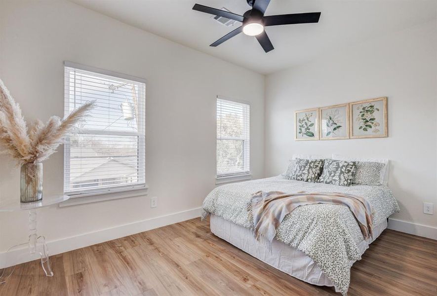 Bedroom featuring hardwood / wood-style flooring and ceiling fan Bedroom featuring hardwood / wood-style flooring and ceiling fan