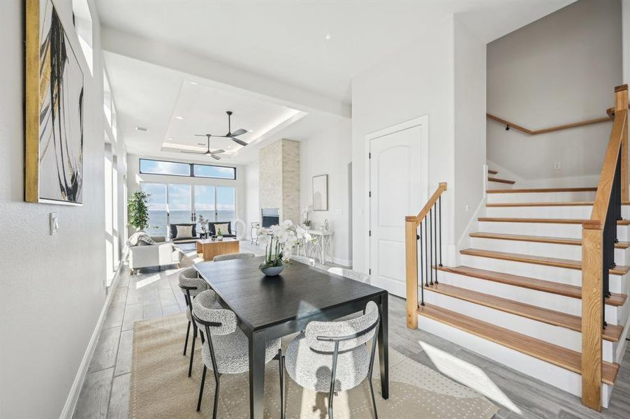 Dining area off kitchen overlooking living room and water views with a wealth of natural light.