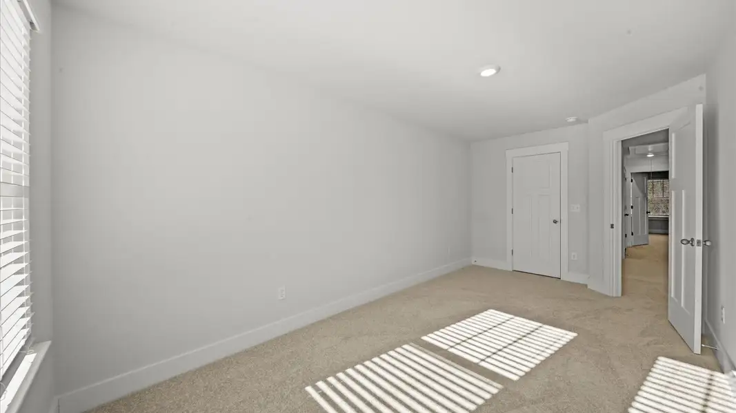 First-class secondary bedroom with comfortable carpeted flooring and generous closet space