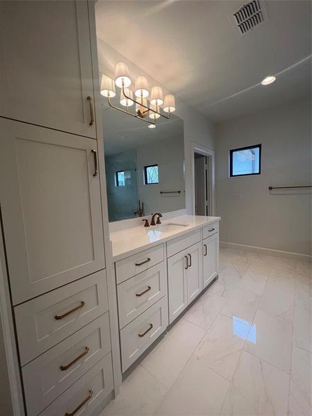 Bathroom featuring vanity, tile floors, and a chandelier