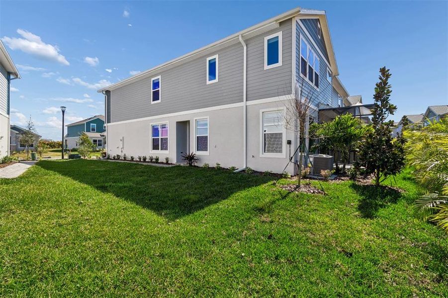 Exterior details and patio area of a home in North River Ranch – Townhomes, Parrish (Image 26).