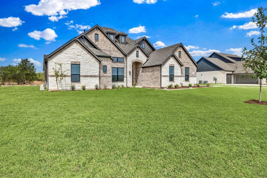 Front exterior of a new home in Legacy Trails, McLendon-Chisholm, TX, highlighting curb appeal (Image 13).