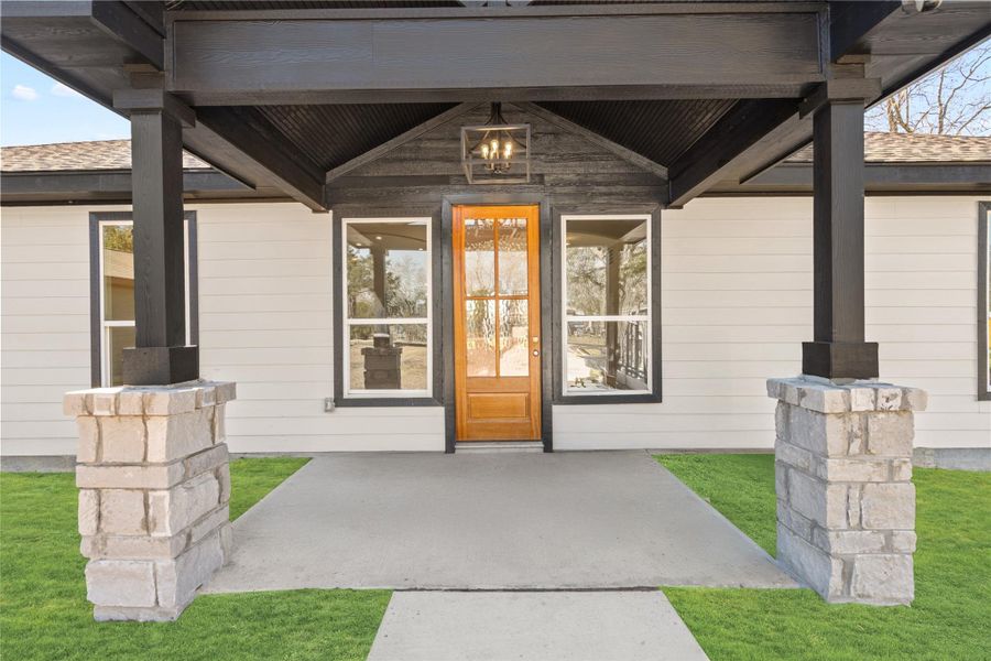 The front porch framed byelegant pillars exudes charmand sophistication, perfectlycomplementing the home’sclean architectural lines.