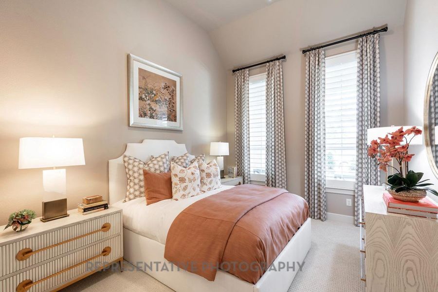 Bedroom with light carpet and vaulted ceiling Bedroom with light carpet and vaulted ceiling