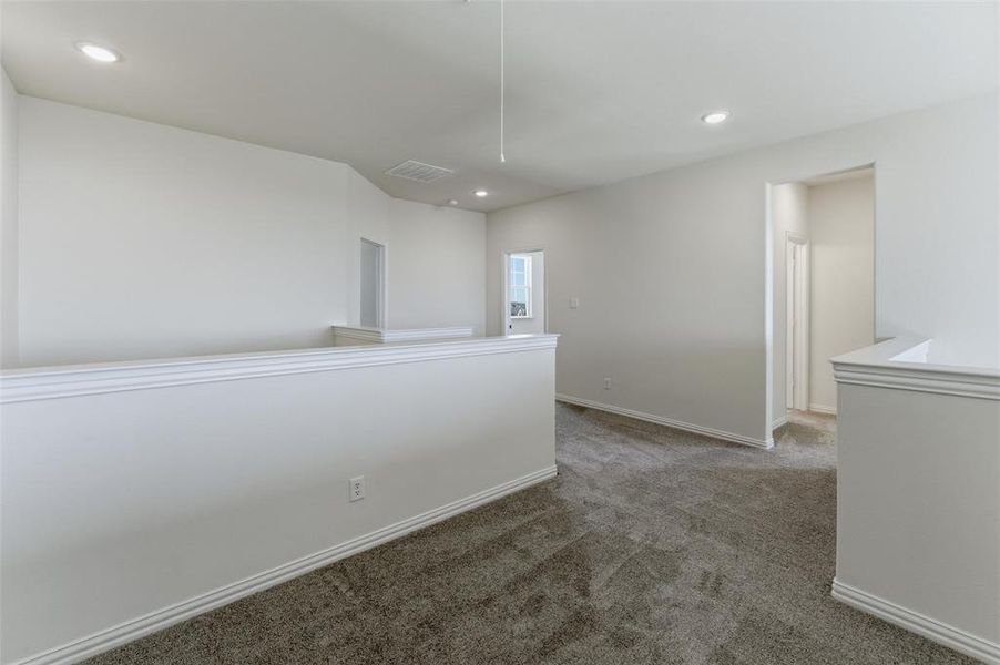 Hallway with light carpet and recessed lighting Hallway with light carpet and recessed lighting