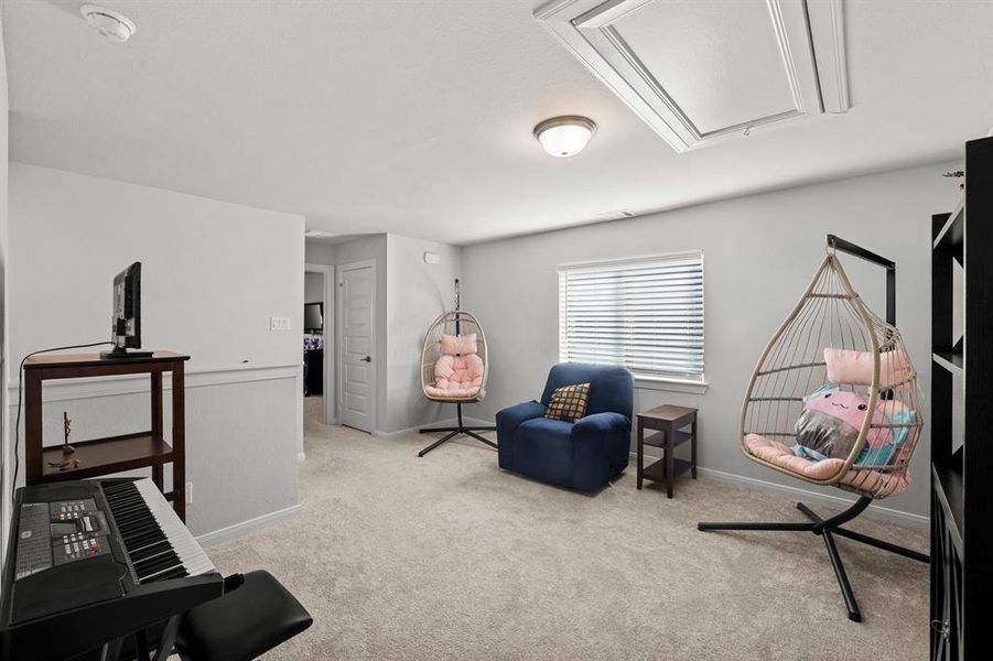 Sitting room featuring light carpet and attic access Sitting room featuring light carpet and attic access